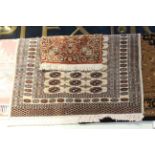 Fawn ground wool rug 1.80 x 1.30 and small red ground wool rug 0.95 x 0.