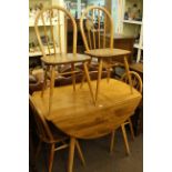 Vintage Ercol elm drop leaf dining table and four Quaker back chairs
