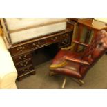 Mahogany eight drawer pedestal desk and ox blood buttoned leather swivel desk chair