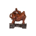 A CHINESE CARVED WOOD FIGURE GROUP, modelled as a boy clambering on the back of a buffalo,