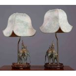 A PAIR OF PATINATED METAL ELEPHANT TABLE LAMPS, on hardwood bases.