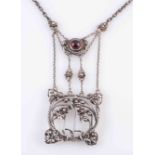 AN ARTS AND CRAFTS SILVER AND GARNET PENDANT,
