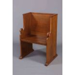 AN OAK PRIESTS CHAIR, of wingback form, carved with rosettes.