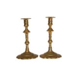 A PAIR OF BRASS PETAL BASE CANDLESTICKS, with knopped stems. 19.