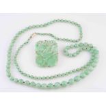 A JADEITE NECKLACE AND JADEITE PLAQUE BROOCH,