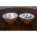 TWO NANKING CARGO BOWLS, each blue painted with sprigs of foliage, the exterior with tea dust glaze,