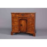 AN EARLY 18TH CENTURY OYSTER VENEERED WALNUT KNEEHOLE DESK, the quarter veneered,