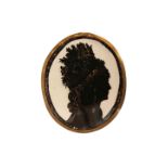 A SILHOUETTE, depicting a lady with elaborate headdress, in an oval frame. 10cm by 8.