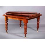 A VICTORIAN STYLE MAHOGANY EXTENDING DINING TABLE, with rounded corners and baluster legs,