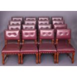 A SET OF SEVENTEEN VICTORIAN OAK AND UPHOLSTERED DINING CHAIRS, each with two-button back,