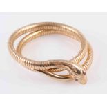 A YELLOW GOLD SNAKE BANGLE BY CROPP AND FARR,