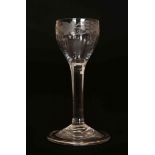 AN 18TH CENTURY FOLDED FOOT WINE GLASS, with engraved and fluted bowl. 13.