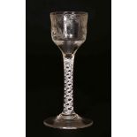 AN 18TH CENTURY WINE GLASS, with opaque twist stem and engraved bowl. 14.