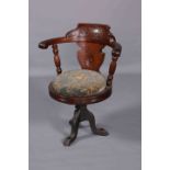 A LATE 19TH CENTURY MAHOGANY REVOLVING SHIPS CHAIR, with cast iron base.