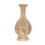 A CHINESE IVORY COLOURED LACQUER VASE, pear shaped, decorated with foliage. 31.