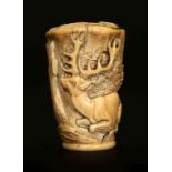 A CARVED IVORY CANE HANDLE, PROBABLY SOUTH GERMAN AND 18TH CENTURY, the top carved with a hound,