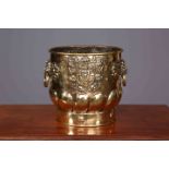 A LATE 19TH CENTURY BRASS JARDINIERE, repousse with crests and lion mask ring handles. 28.