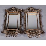 A PAIR OF SILVERED COMPOSITION GIRANDOLE MIRRORS,