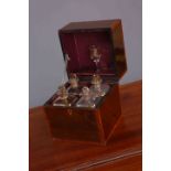A GEORGE III MAHOGANY AND CROSSBANDED DECANTER BOX, containing four gilded decanters and a glass.