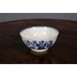 A FIRST PERIOD WORCESTER BLUE AND WHITE BOWL, painted with floral sprays, crescent mark.