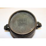A CHINESE LEADED BRONZE TWO-HANDLED CUP, cylindrical with half quatrefoil handles and recessed foot,