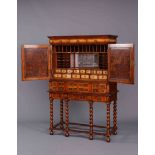 AN OYSTER VENEERED WALNUT CABINET ON STAND IN WILLIAM AND MARY STYLE,