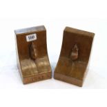 ROBERT THOMPSON OF KILBURN A PAIR OF MOUSEMAN OAK BOOKENDS, DATED 1982, of characteristic form,