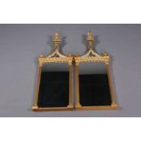 A PAIR OF FEDERAL STYLE GILDED AND VERRE EGLOMISE MIRRORS, each with pineapple finial above,