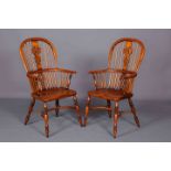 A PAIR OF ELM AND BEECH WINDSOR CHAIRS, each with crinoline stretcher and saddle seat.