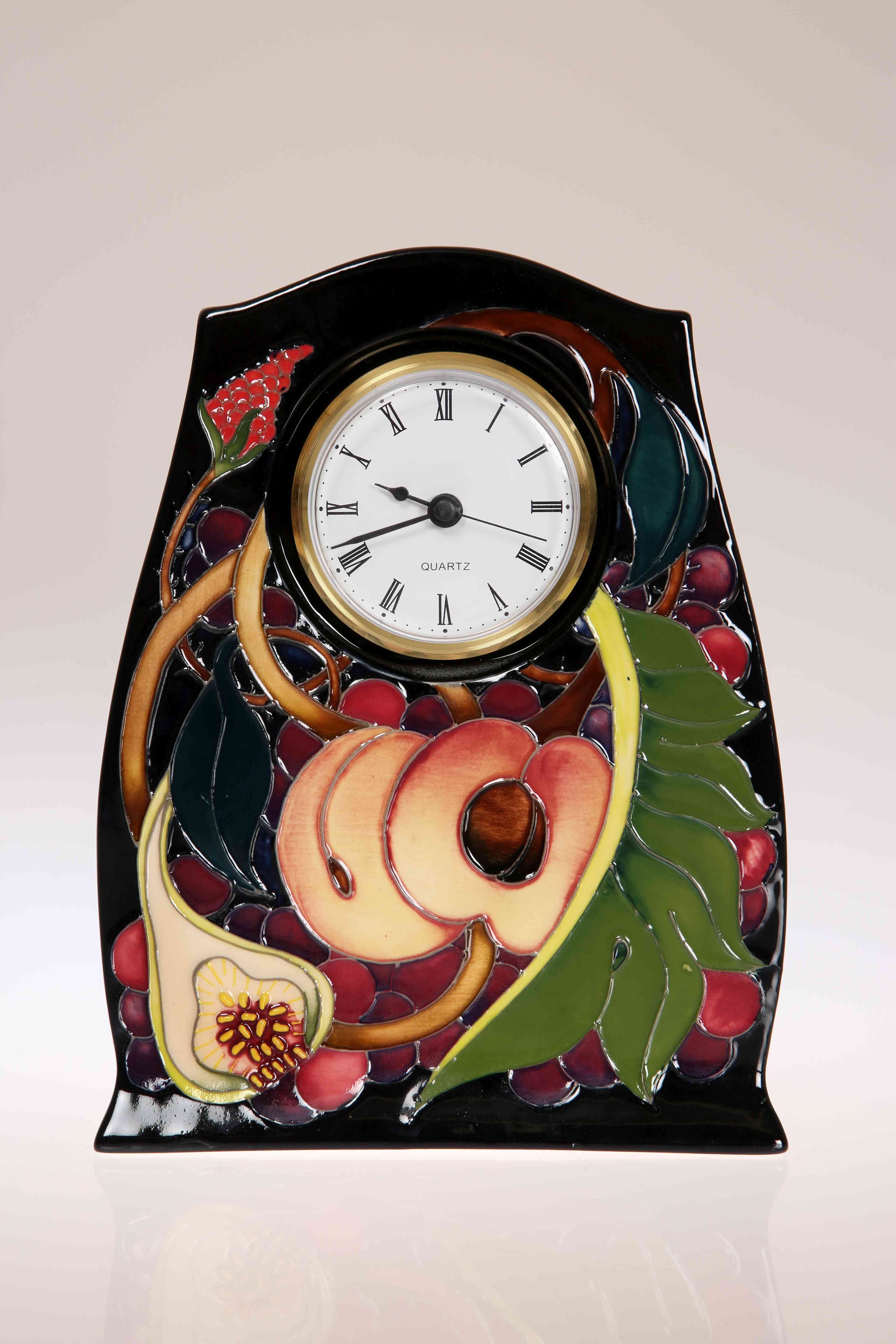 A MOORCROFT "QUEENS CHOICE" MANTEL CLOCK, first quality.