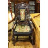 Victorian ornately carved elbow chair with needlework panel back and seat