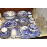 Collection of blue and white Willow pattern tableware, three tantalus decanters,