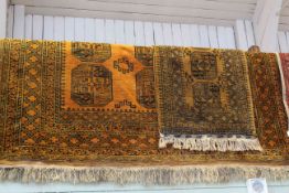 Two Oriental wool carpets and rug with burnt orange ground