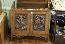 Early 20th Century oak wall cabinet having two carved panel doors