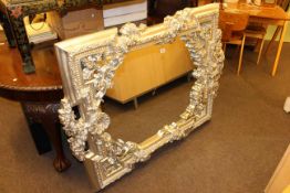 Ornate silvered framed wall mirror