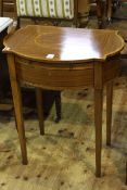 Satinwood banded serpentine shaped writing table having leather inset slide above a drawer on