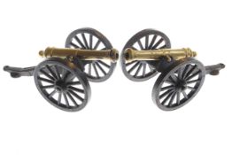 Pair of cast metal and brass model table canons