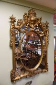 19th Century style gilt framed mirror, embellished with putti and swags,