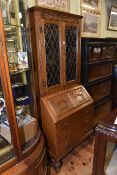 Carved oak bureau bookcase with leaded glazed doors