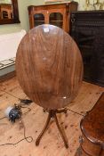 Oval mahogany snap top occasional table on pedestal base