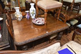 Victorian carved oak extending dining table with leaf and winder together with six carved oak