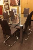 Contemporary glass top dining table and six leather and chrome finish chairs