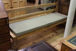 Stripped pine bench, with turned baluster legs,
