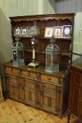Oak dresser and rack, the base with three drawers and three-panel doors,