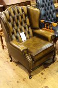 WITHDRAWN Deep buttoned leather wing chair with short cabriole legs