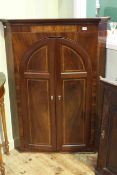 Early 19th Century inlaid mahogany corner cupboard, with arched double doors,