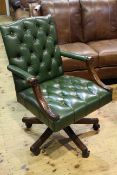 Handsome deep buttoned green leather and mahogany desk chair in Georgian style