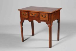 A GEORGE III MAHOGANY LOWBOY, the moulded rectangular top above three drawers,