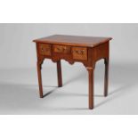 A GEORGE III MAHOGANY LOWBOY, the moulded rectangular top above three drawers,