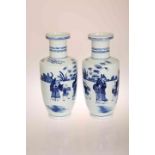A NEAR PAIR OF CHINESE BLUE AND WHITE ROULEAU VASES, each painted with figures,